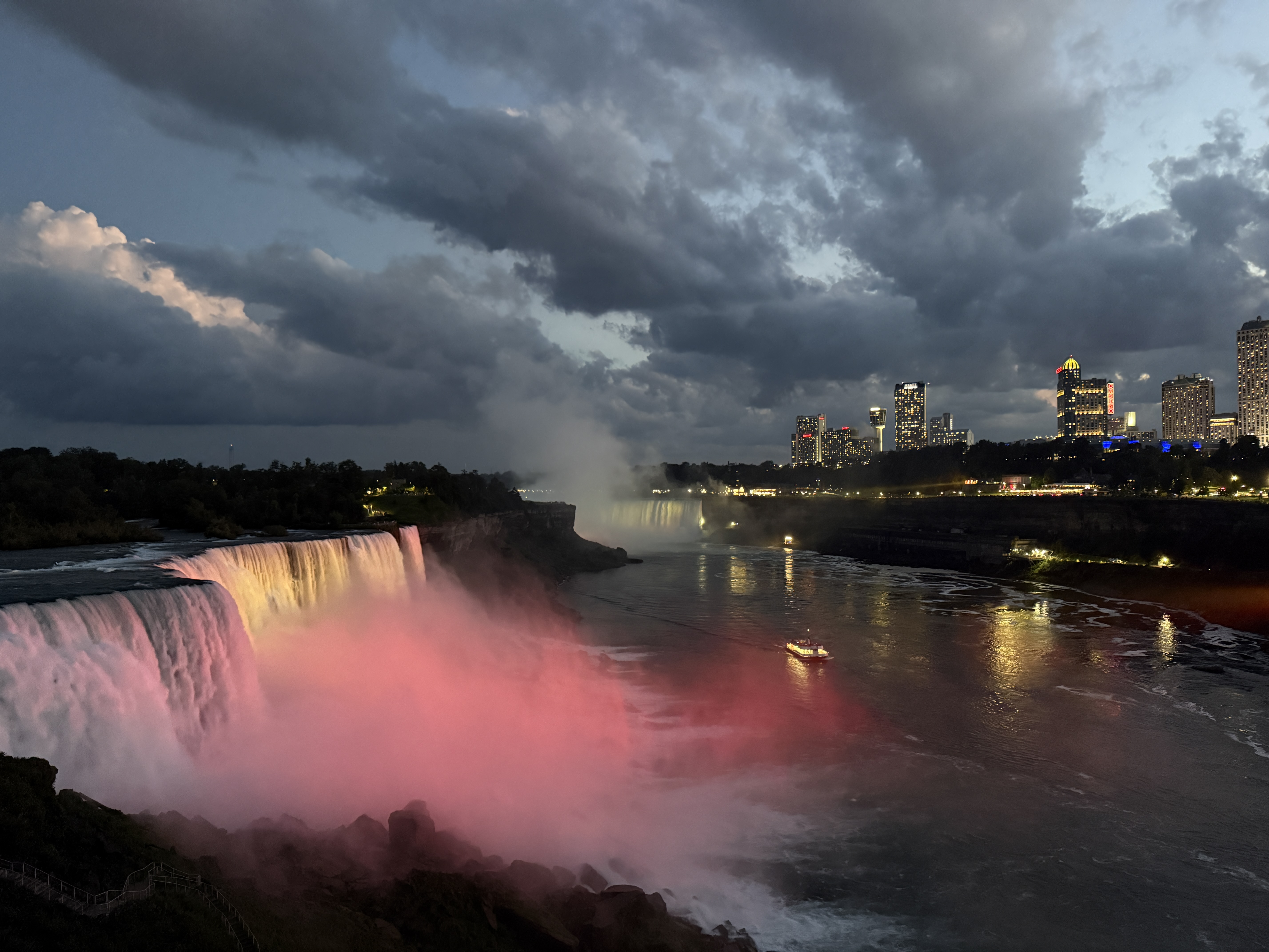 Lights shine on the American Falls as the Maid of the Mist returns to port