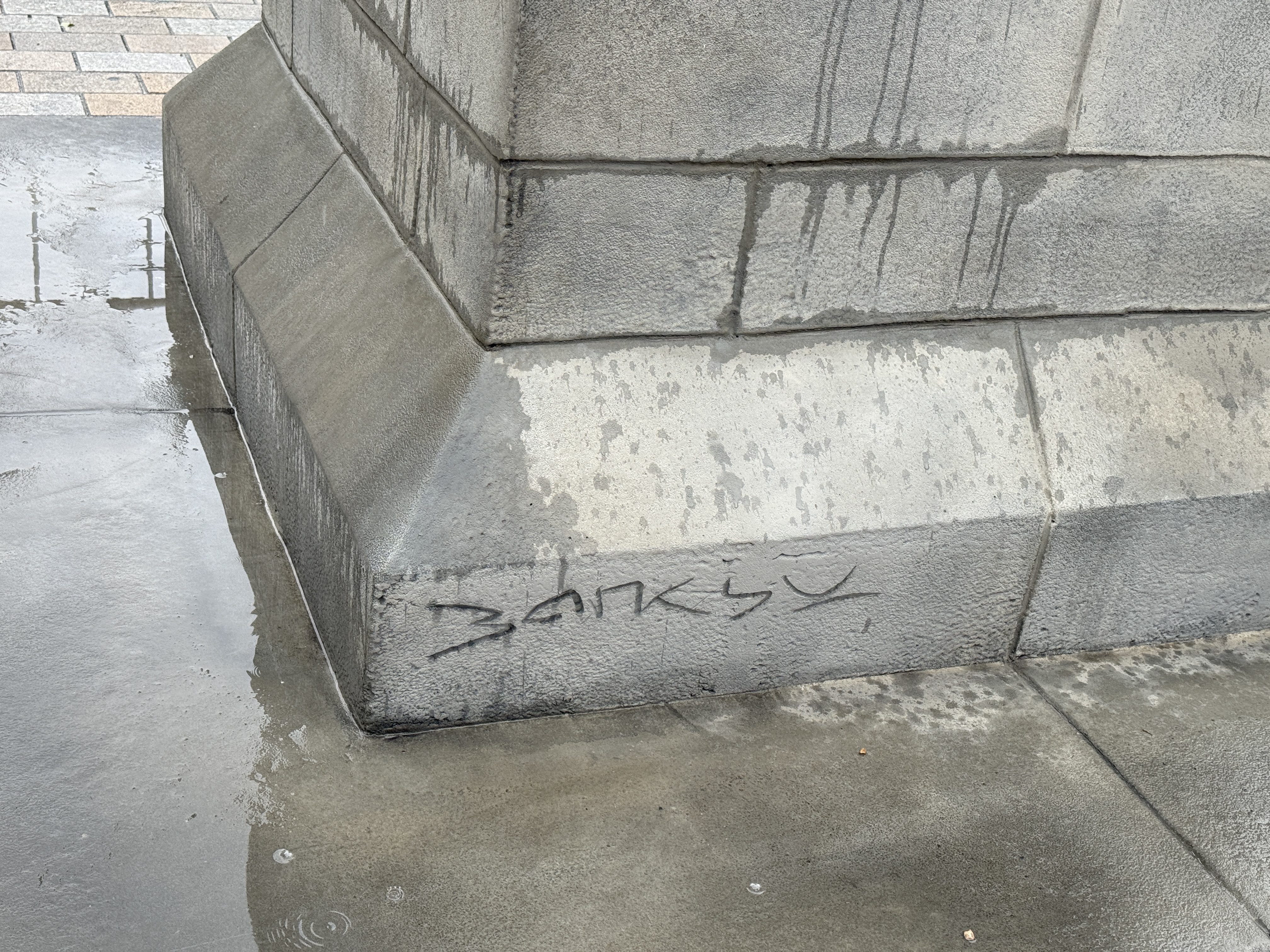 The Banksy signature on the plinth